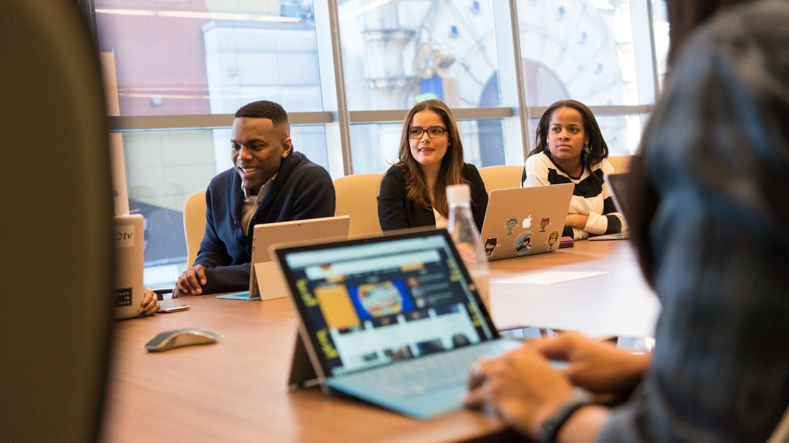 staff discussing payroll for recruitment agencies in a meeting room