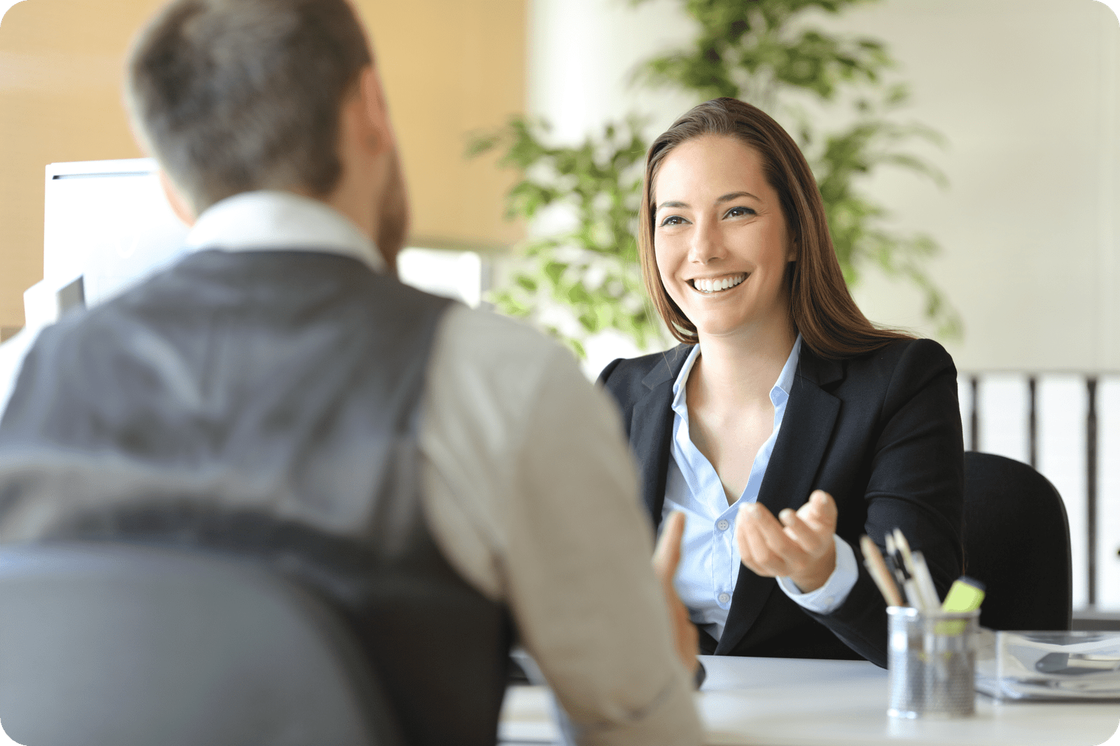 two people smiling in a meeting