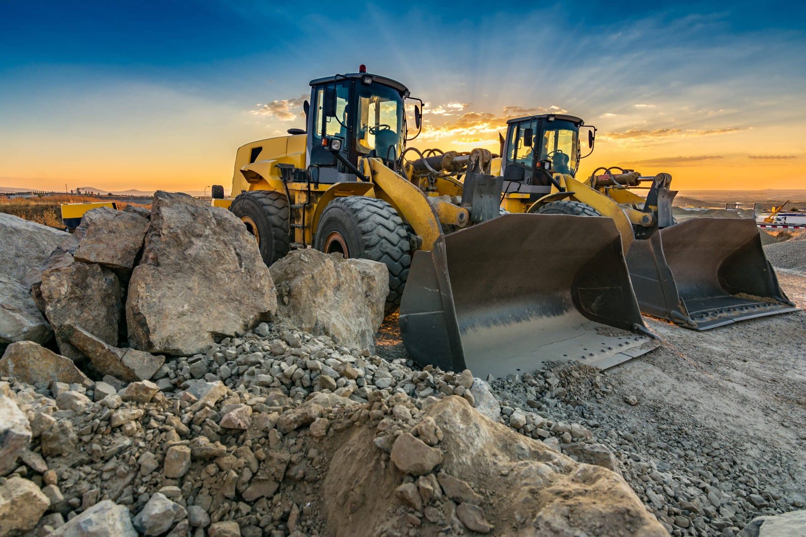 Two excavators removing stone in the construction works